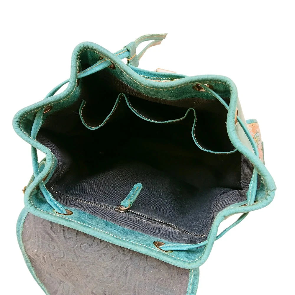 Woman wearing teal printed floral leather backpack — boho style ladies bag, buy online Pakistan