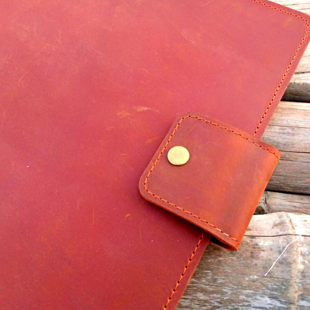 Blue leather tech organizer with pen, credit card, and file compartments